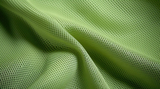 Close-up of breathable fabric showcasing mesh design in light green for Breathable Footwear Design.